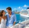 Pareja en la cubierta con los edificios de Miami y un crucero al fondo