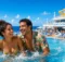 Pareja riendo dentro de la piscina de la cubierta de un crucero